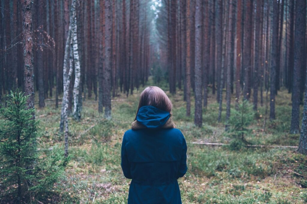 Lady entering a forest path